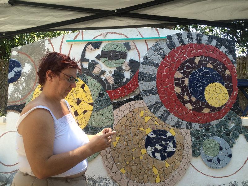 Julie hard at work setting tile 
