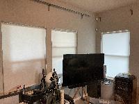 Living room - curtain rods, but no curtains 
